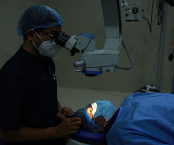 Eye surgeon operating with a surgical microscope at VisionCare