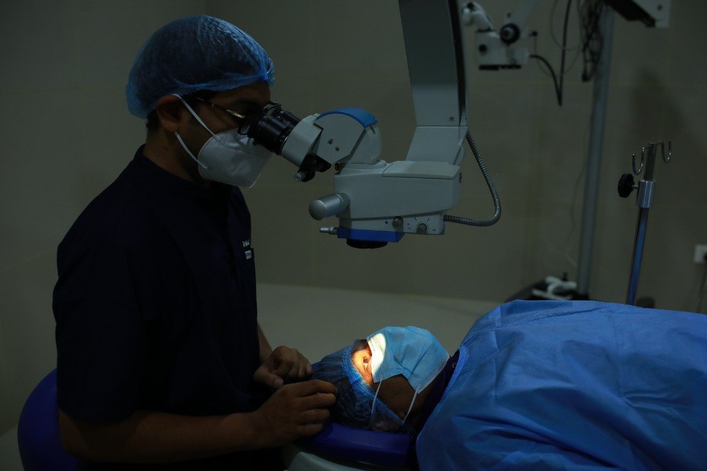 Eye surgeon operating with a surgical microscope at VisionCare